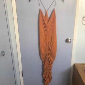 Sun becomes her orange ruched dress